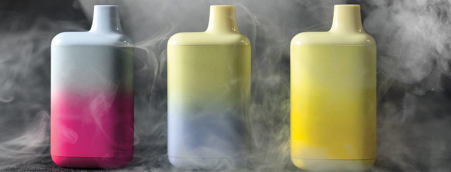 Image of three vapes surrounded by clouds of smoke