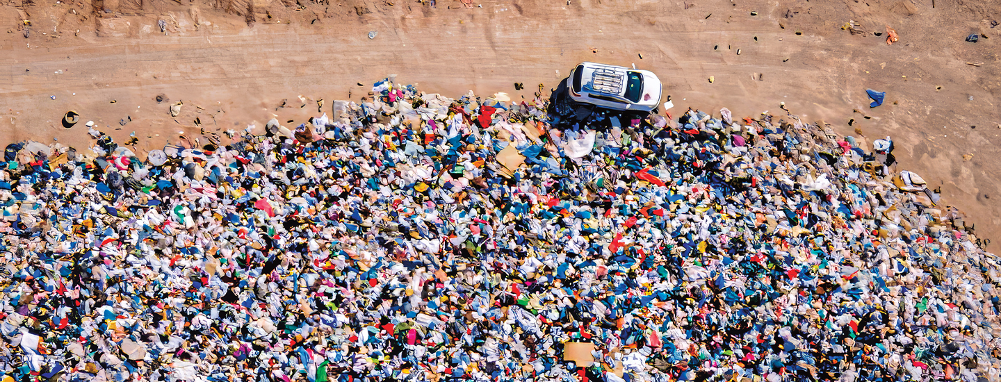 Bird&apos;s eye photo of a huge dump filled with thrown away clothes