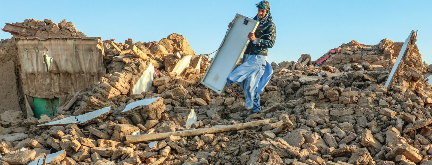 Image of a person standing in a large heap of rubble