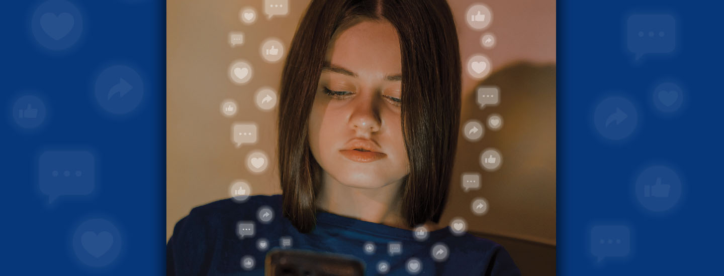 A girl looks down at a phone surrounded by floating social media reaction icons