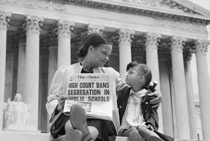 A mother and her daughter sitting outside of the Supreme Court