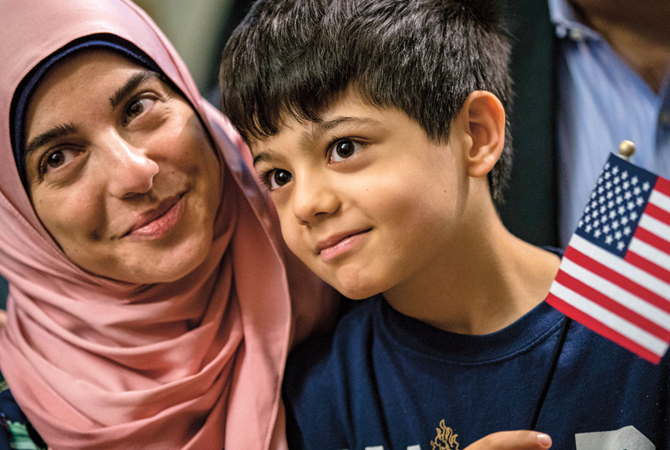 Woman in a hijab holding her son