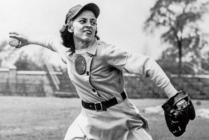 A woman pitching a baseball